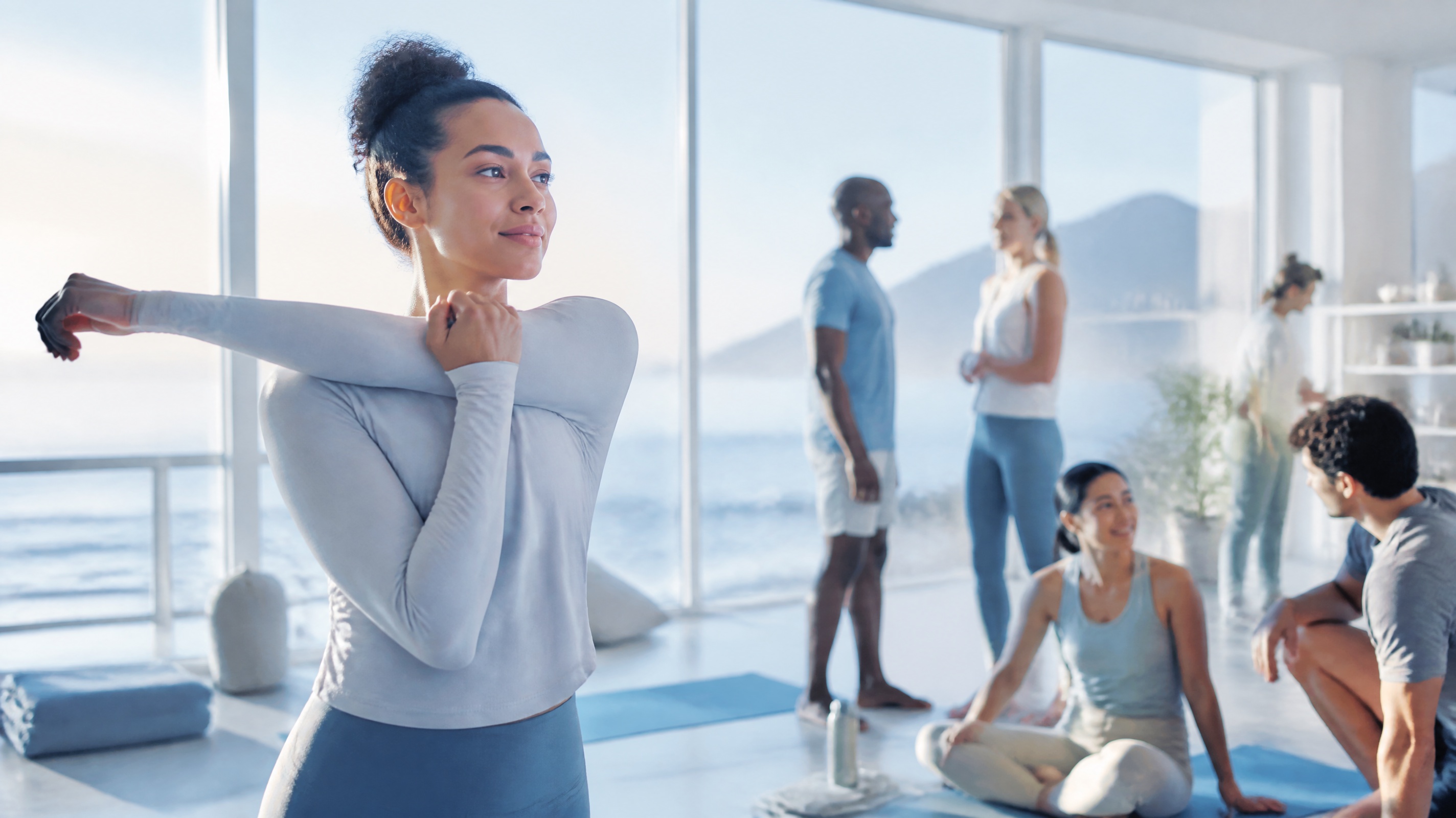 Blue Oxygen community members moving together in a bright coastal studio